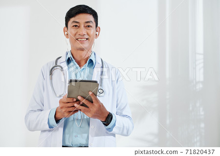 Middle-aged doctor making video call Middle-aged doctor making video call 71820437