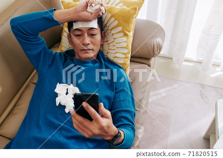 Sick man resting on sofa Sick man resting on sofa 71820515
