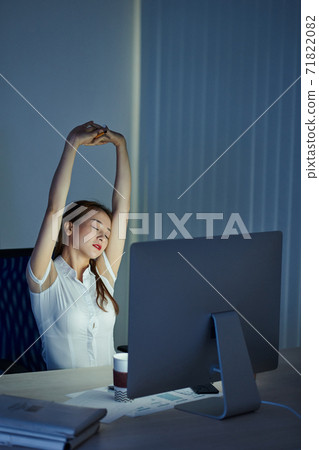 Businesswoman stretching her back Businesswoman stretching her back 71822082