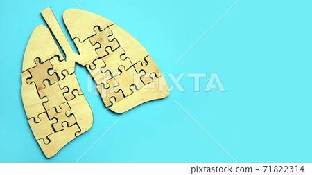 Lungs from pieces of puzzles on the blue background. 71822314