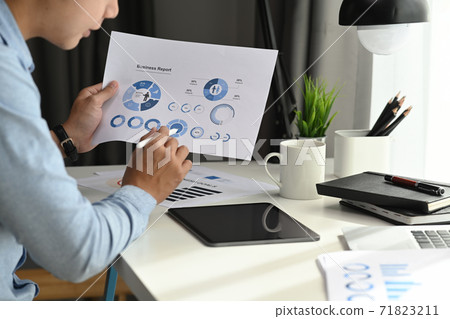 A businessman is developing a business project and analyzing market data information on a tablet computer. A businessman is developing a business project and analyzing market data information on a tablet computer. 71823211