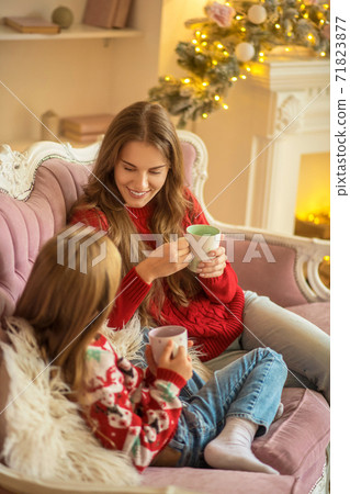 Cute family sitting on the sofa and feeling comfortable Cute family sitting on the sofa and feeling comfortable 71823877