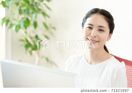 A young woman working on a computer A young woman working on a computer 71823897