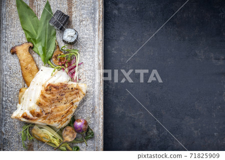 Traditional modern style Japanese fried skrei cod fish filet with bok choi and sushi rolls Traditional modern style Japanese fried skrei cod fish filet with bok choi and sushi rolls 71825909