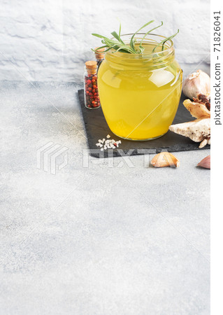 Homemade beef bone and vegetable broth with turmeric seasoning in a glass jar for storage and carrying. Healthy food with collagen and amino acids. Copy space. Homemade beef bone and vegetable broth with turmeric seasoning in a glass jar for storage and carrying. Healthy food with collagen and amino acids. Copy space. 71826041