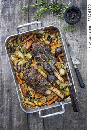 Traditional venison knuckle with fried potatoes and vegetable Traditional venison knuckle with fried potatoes and vegetable 71826590