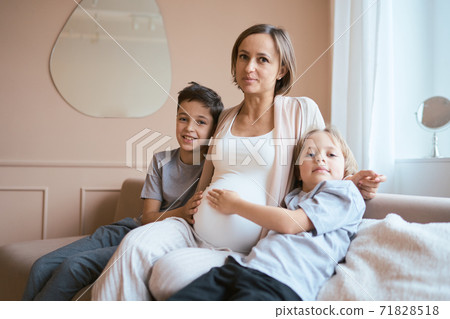 Beautiful pregnant woman with her sons 71828518