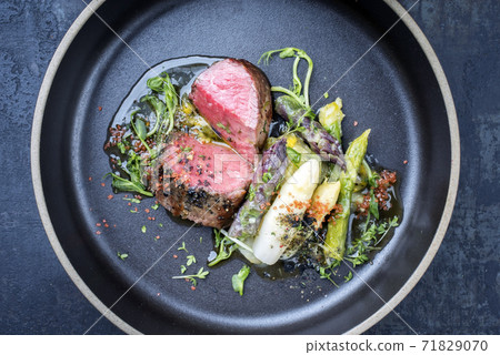 German asparagus potato salad with barbecue dry aged sliced fillet steak 71829070
