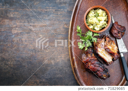 Traditional Bavarian pork knuckle with potato salad  71829085