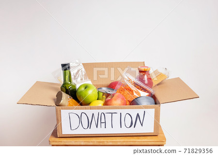 A box full of canned and packaged food for a charity A box full of canned and packaged food for a charity 71829356
