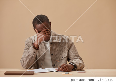 Exhausted man at workplace Exhausted man at workplace 71829540