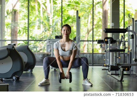 Happy Asian Sporty young woman in sportswear workout and exercise with dumbbells at modern gym,Sport and Recreation Concept Happy Asian Sporty young woman in sportswear workout and exercise with dumbbells at modern gym,Sport and Recreation Concept 71830653