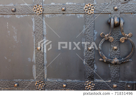 Close-up of the old iron black door Close-up of the old iron black door 71831496