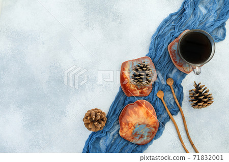 Coffee cup and resin art plates on blue background. Flat lay, top view Coffee cup and resin art plates on blue background. Flat lay, top view 71832001
