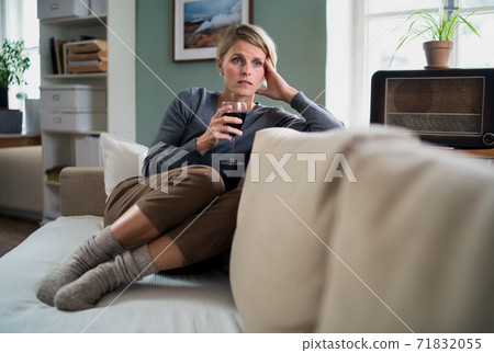Depressed woman with wine indoors at home, mental health and alcohol addiction concept. Depressed woman with wine indoors at home, mental health and alcohol addiction concept. 71832055