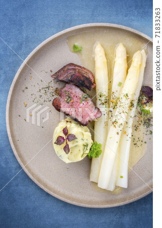 barbecue dry aged sliced fillet steak with white asparagus in butter sauce and mashed potatoes  71833263