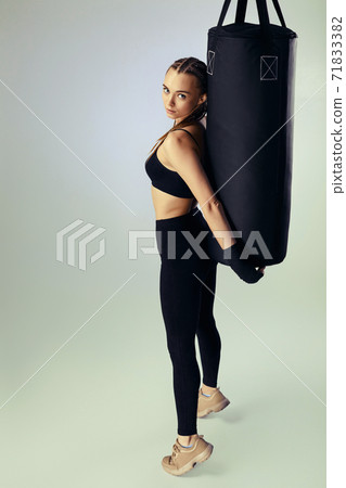 woman in sportswear with boxing bandages near bag 71833382