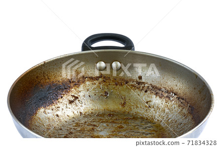 Close up burning mark, oily stains after cooking on iron frying pan. Ingrain burning on iron pan, big area of oily stains, burnt black blemish. Isolated on white background. 71834328