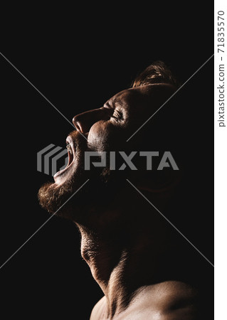 Man screams with his head thrown back. 71835570