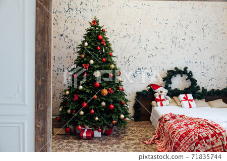 Beautiful decorated room with Christmas tree with presents under it 71835744