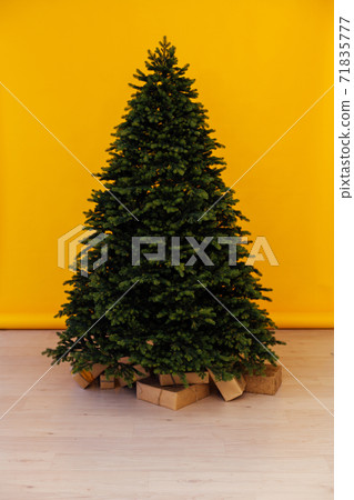 Beautiful holdiay decorated room with Christmas tree with presents under it 71835777