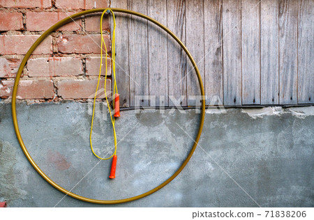 Hoop and skipping rope hanging on wall Hoop and skipping rope hanging on wall 71838206