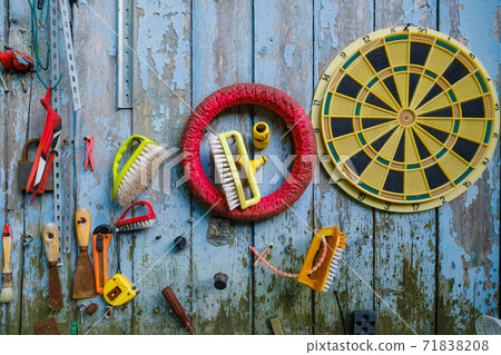 Various tools and supplies hanging on shabby wooden wall Various tools and supplies hanging on shabby wooden wall 71838208