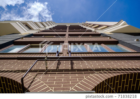 Exterior of modern multistory city building with brick facade Exterior of modern multistory city building with brick facade 71838218