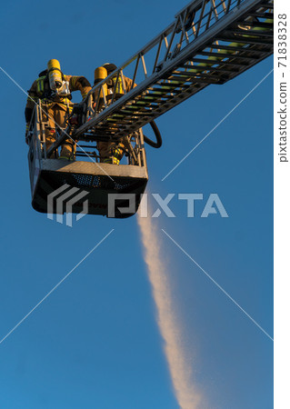 Firefighters extinguishing a blaze Firefighters extinguishing a blaze 71838328