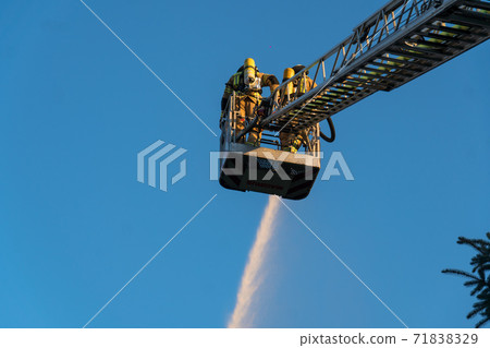 Firefighters extinguishing a blaze Firefighters extinguishing a blaze 71838329
