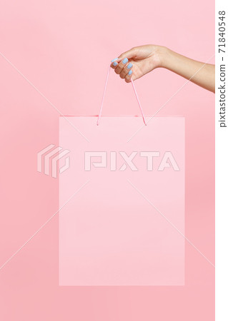 Discount times and modern shopping. Hand of young african american woman holding paper bag 71840548