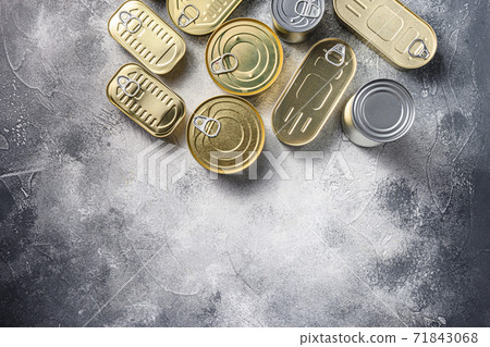 Assortment types of shapes canned food, fish , fruits, vegetables, meat, soup top view on grey rustic background top view space for text. 71843068