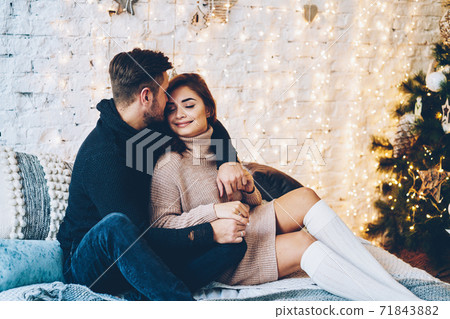 Happy caucasian couple in love having fun together near beautiful Christmas tree Happy caucasian couple in love having fun together near beautiful Christmas tree 71843882