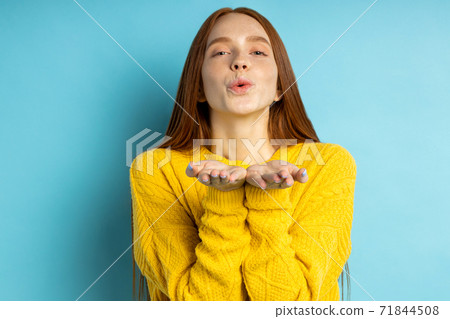 Studio shot of redhead caucasian young woman isolated blue background Studio shot of redhead caucasian young woman isolated blue background 71844508