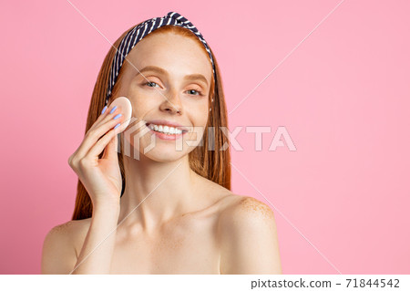 Beautiful woman with cosmetic sponge 71844542