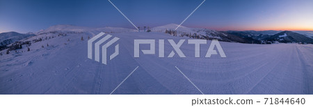 Alpine resort prepared ski slopes and lifts. Pre sunrise morning mountain ridge view. Dragobrat, Ukraine Carpathians. Alpine resort prepared ski slopes and lifts. Pre sunrise morning mountain ridge view. Dragobrat, Ukraine Carpathians. 71844640