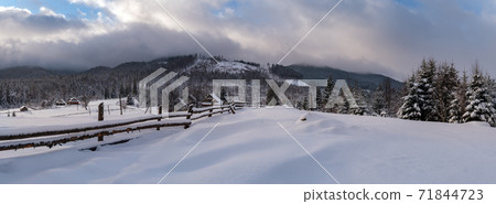 Countryside hills, groves and farmlands in winter remote alpine mountain village Countryside hills, groves and farmlands in winter remote alpine mountain village 71844723