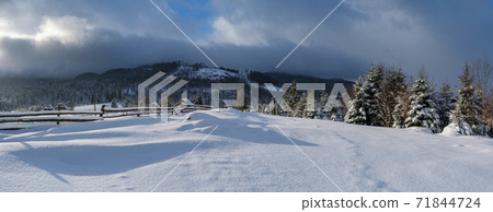 Countryside hills, groves and farmlands in winter remote alpine mountain village. Panorama. Countryside hills, groves and farmlands in winter remote alpine mountain village. Panorama. 71844724