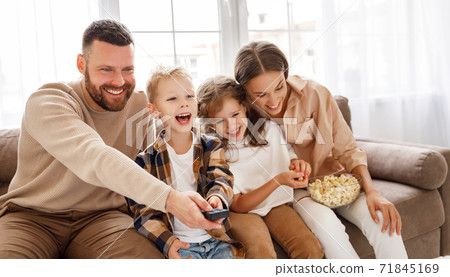 Happy family watching tv together. Happy family watching tv together. 71845169