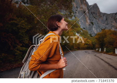 Outdoor fashion photo of young beautiful lady surrounded autumn forest in mountains 71845370