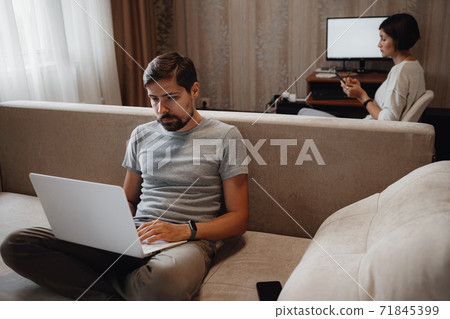 Couple Working And Playing With Laptop Computer At Home 71845399