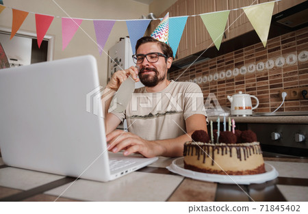 Man celebrating birthday online in quarantine time. Man celebrating birthday online in quarantine time. 71845402