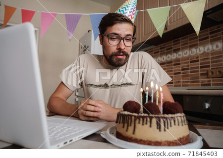 Man celebrating birthday online in quarantine time. Man celebrating birthday online in quarantine time. 71845403