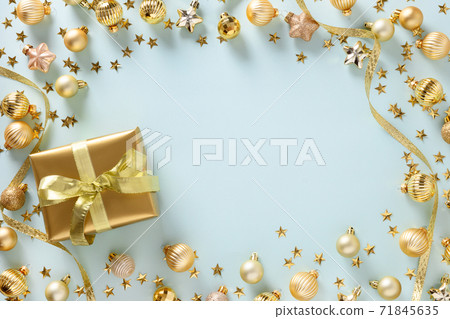 Christmas frame of golden gift and balls on blue. 71845635