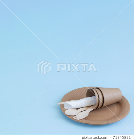 Disposable eco friendly bamboo wood and paper utensils on blue background Disposable eco friendly bamboo wood and paper utensils on blue background 71845851