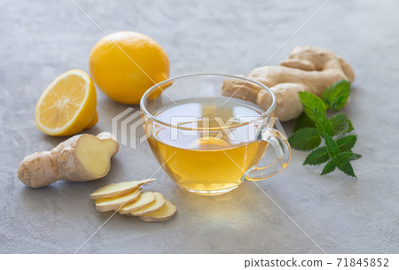 Transparent cup of healthy hot ginger tea with mint and lemon Transparent cup of healthy hot ginger tea with mint and lemon 71845852