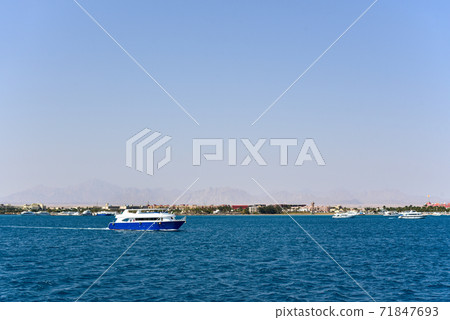 The yacht sails on the sea along the coast in Africa The yacht sails on the sea along the coast in Africa 71847693