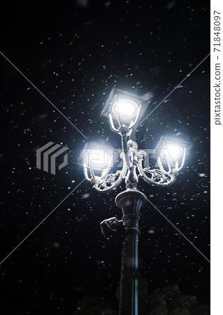 Old street lamp in snowfall during the winter night Old street lamp in snowfall during the winter night 71848097