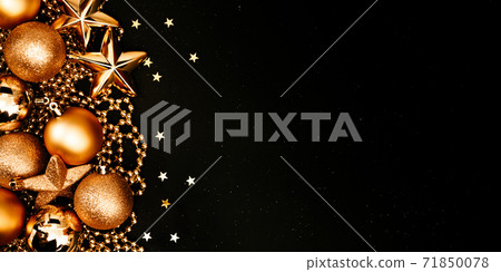 Christmas and New Year banner with copy space. Golden balls and stars on black backdrop. Christmas and New Year banner with copy space. Golden balls and stars on black backdrop. 71850078