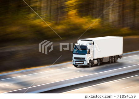 White truck with white trailer on the road in autumn 71854159